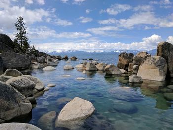 Rocks in sea against sky