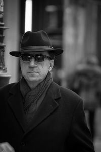 Man in a coat with glasses and a hat 