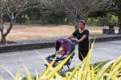 Family happy little baby learning to walk with mother help at home.