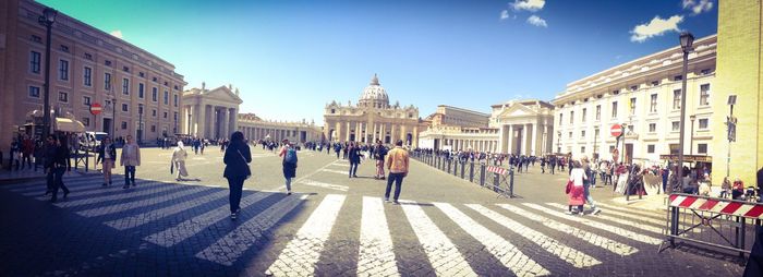Group of people walking in front of buildings