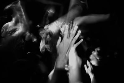 Close-up of hands and flowers against blurred background