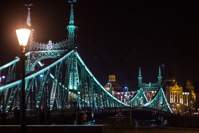 Illuminated bridge at night