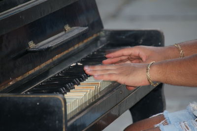 Midsection of man playing piano