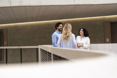 Multiracial business business colleagues discussing in corridor