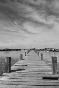 Wooden jetty on pier at sea against sky