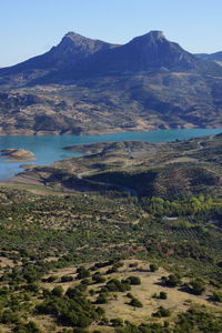 Scenic view of river and mountains against sky