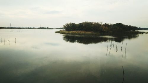 Reflection of trees in lake against sky