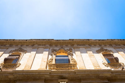 Low angle view of building against blue sky