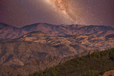 Scenic view of mountains against sky at night