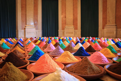 Colorful powder paint in bowls arranged against columns