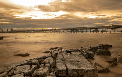 Scenic view of bay against sky during sunset