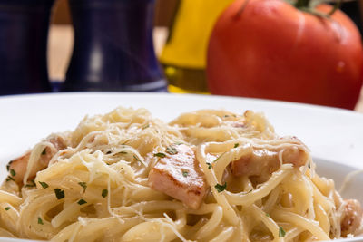 Close-up of spaghetti with carbonara in plate on table