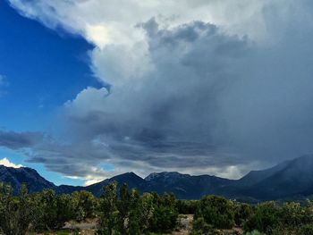 Scenic view of mountains against cloudy sky