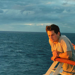 Man looking at sea against sky