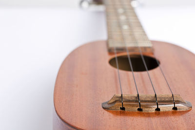 Close-up of wooden musical instrument over white background