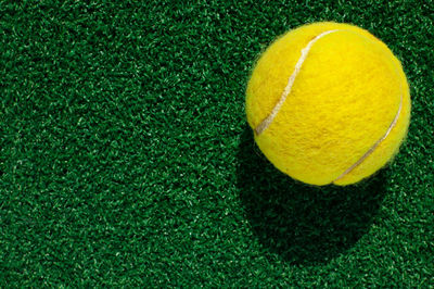 Close-up of yellow ball on grass