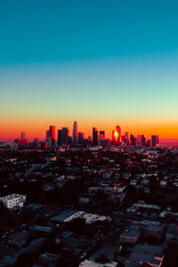 Cityscape against clear sky during sunset