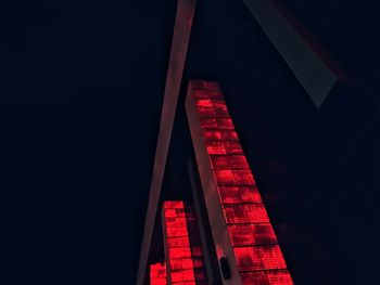 Low angle view of illuminated building against sky at night