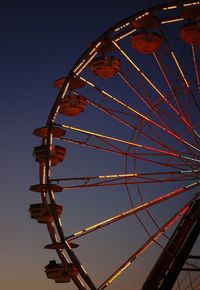 Low angle view of ferris wheel against clear sky