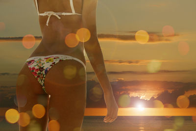 Close-up of woman at beach during sunset