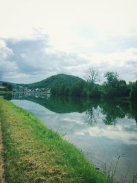 Scenic view of lake against cloudy sky