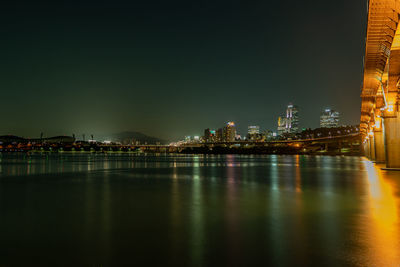 Illuminated buildings at waterfront