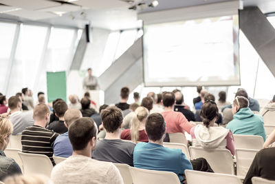 Rear view of people sitting in classroom