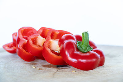 Close-up of chopped tomatoes on table against white background