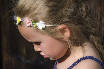 Close-up portrait of a girl with pink flower