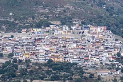 High angle view of townscape against mountain. the colorful houses of osini in sardinia, italy.