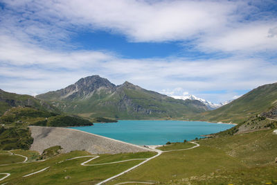 Scenic view of lake of mont cenis and alps mountains against sky