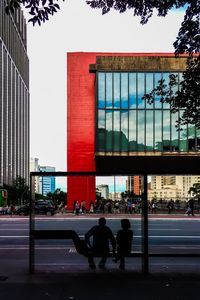 People walking on road against buildings