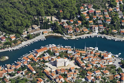 High angle view of townscape by river in city