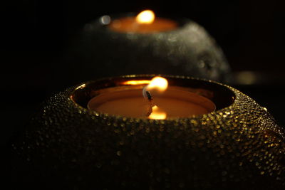 Close-up of illuminated tea light candle