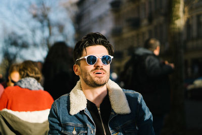 Handsome man wearing sunglasses in city