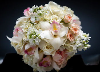 Close-up of white rose bouquet against black background