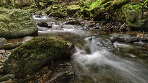 Scenic view of river flowing through rocks