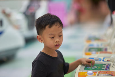 Boy looking at arcade game