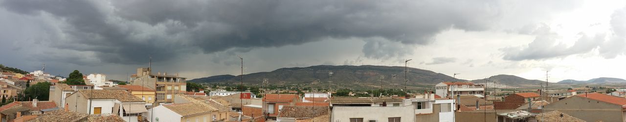 Town against cloudy sky