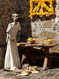 Statue of people standing by stone wall