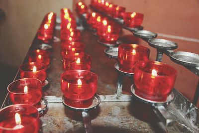 High angle view of illuminated candles on table