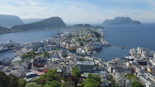 High angle view of city by sea against sky