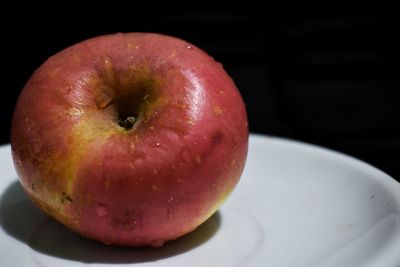 Close-up of wet apple on table