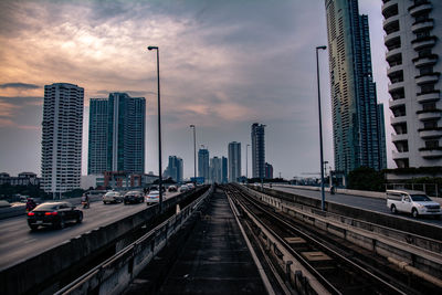 Modern buildings in city against sky during sunset