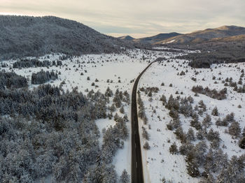 Aerial view of the road during winter with snow on dusk. lika, croatia