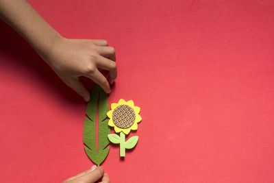 Close-up of woman hand on red background