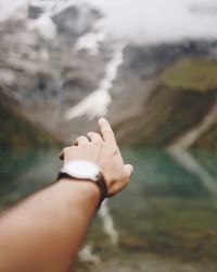 Close-up of hand pointing outdoors