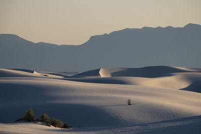 Scenic view of snowcapped mountains against clear sky