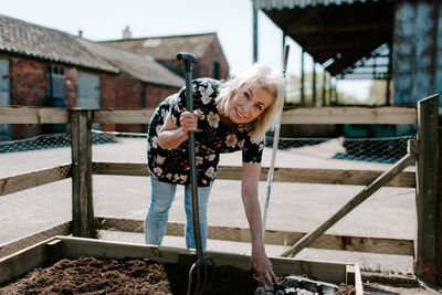 Portrait of woman digging on land