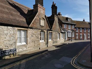 Street amidst buildings against sky